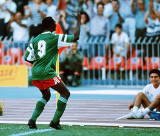 Roger Milla dances by the corner flag after scoring for Cameroon at the 1990 World Cup.