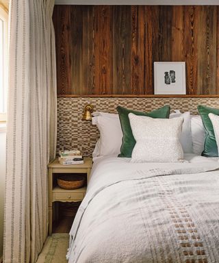 Bedroom with wood panelled walls