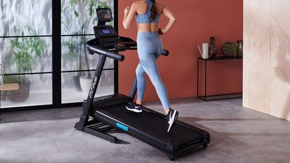 JTX Sprint 5 review: pictured here, a person running on a JTX Sprint 5 folding treadmill, the subject of this review