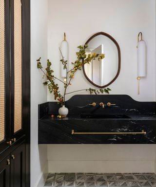 A white bathroom with a black statement sink