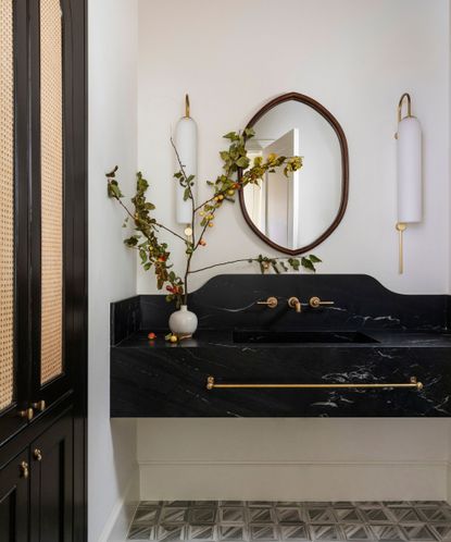 A white bathroom with a black statement sink