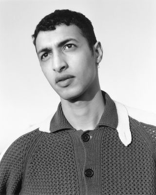 Man in black and white wearing polo top