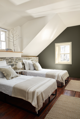 A bedroom with dark green walls