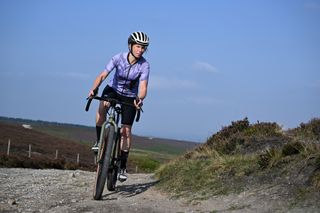 Cyclist cornering a gravel trail on the Cotic Cascade gravel bike