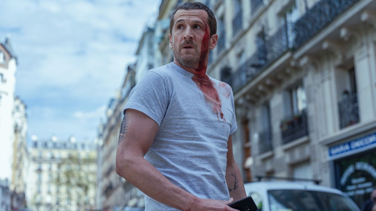 A bloody Franck Lazareff (Guillaume Canet) in a white t shirt in Netflix&#039;s &quot;Ad Vitam&quot;