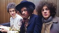 American guitarist and singer Jimi Hendrix (1942-1970) seated in centre with, on left, drummer Mitch Mitchell (1946-2008) and, on right, bassist Noel Redding (1945-2003) of the Jimi Hendrix Experience in London, circa August 1967.