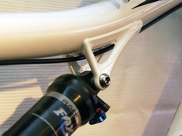 The upper shock mount is bonded to the top tube.