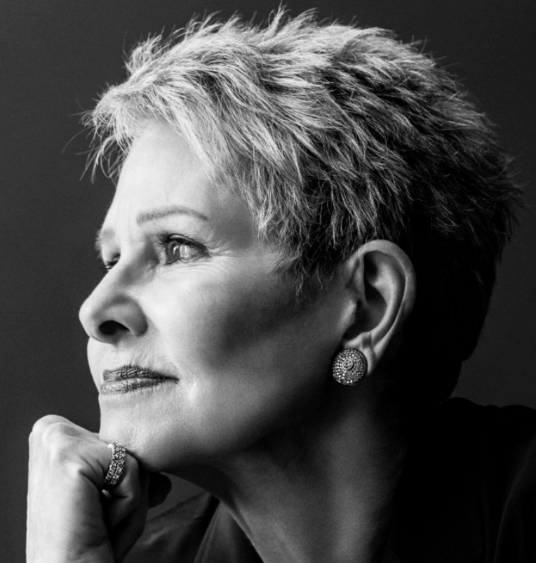 a black and white photo of a white woman with short gray hair