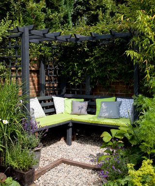 black painted pergola with built-in bench