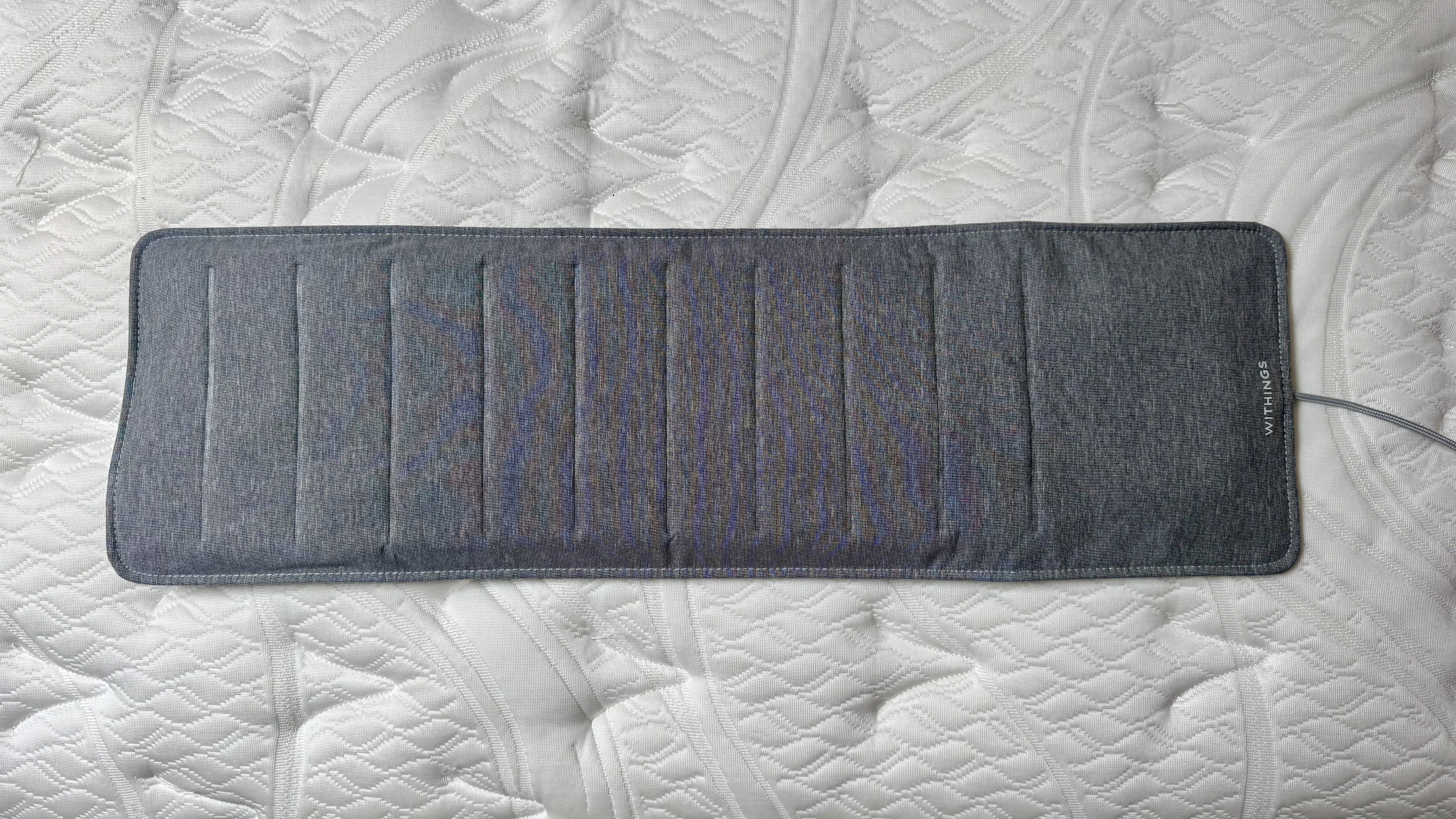 Grey Withings Sleep Tracking mat on white mattress