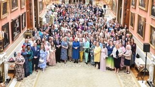 A general view as Queen Camilla poses with guests as she hosts a reception recognising those who support survivors of sexual assault and the relaunch of the Wash Bags Project at Buckingham Palace on May 1, 2024