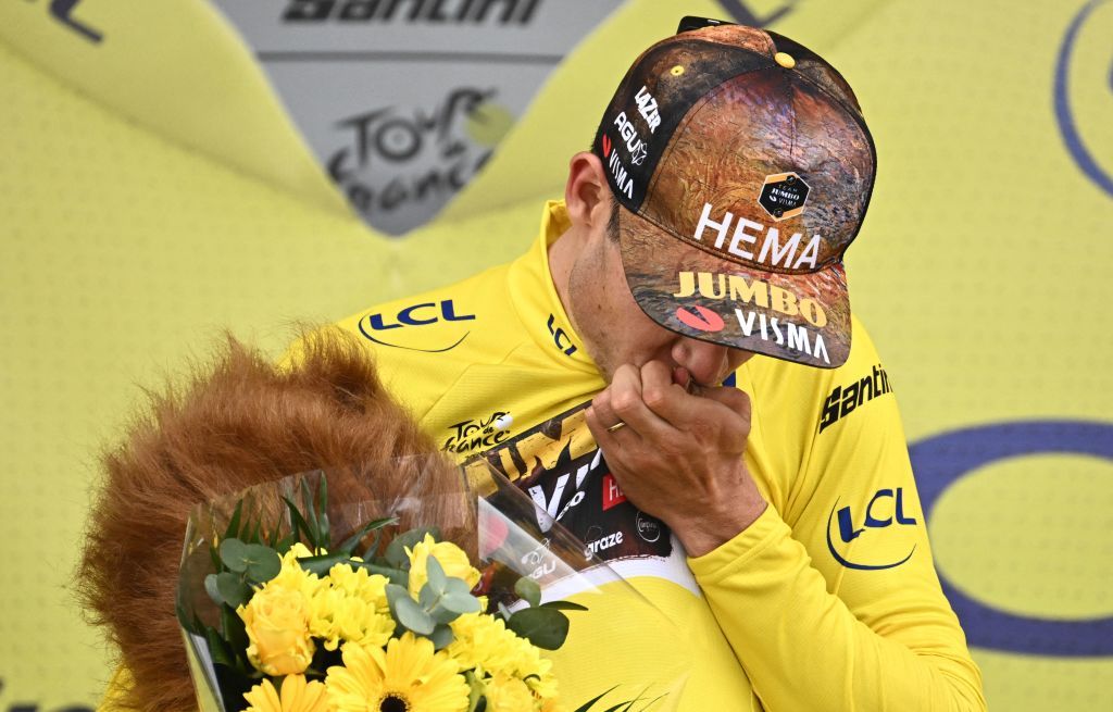 JumboVisma teams Belgian rider Wout Van Aert wearing the overall leaders yellow jersey gestures on the podium after the 5th stage of the 109th edition of the Tour de France cycling race 1537 km between Lille and Arenberg Porte du Hainaut in northern France on July 6 2022 Photo by Marco BERTORELLO AFP Photo by MARCO BERTORELLOAFP via Getty Images
