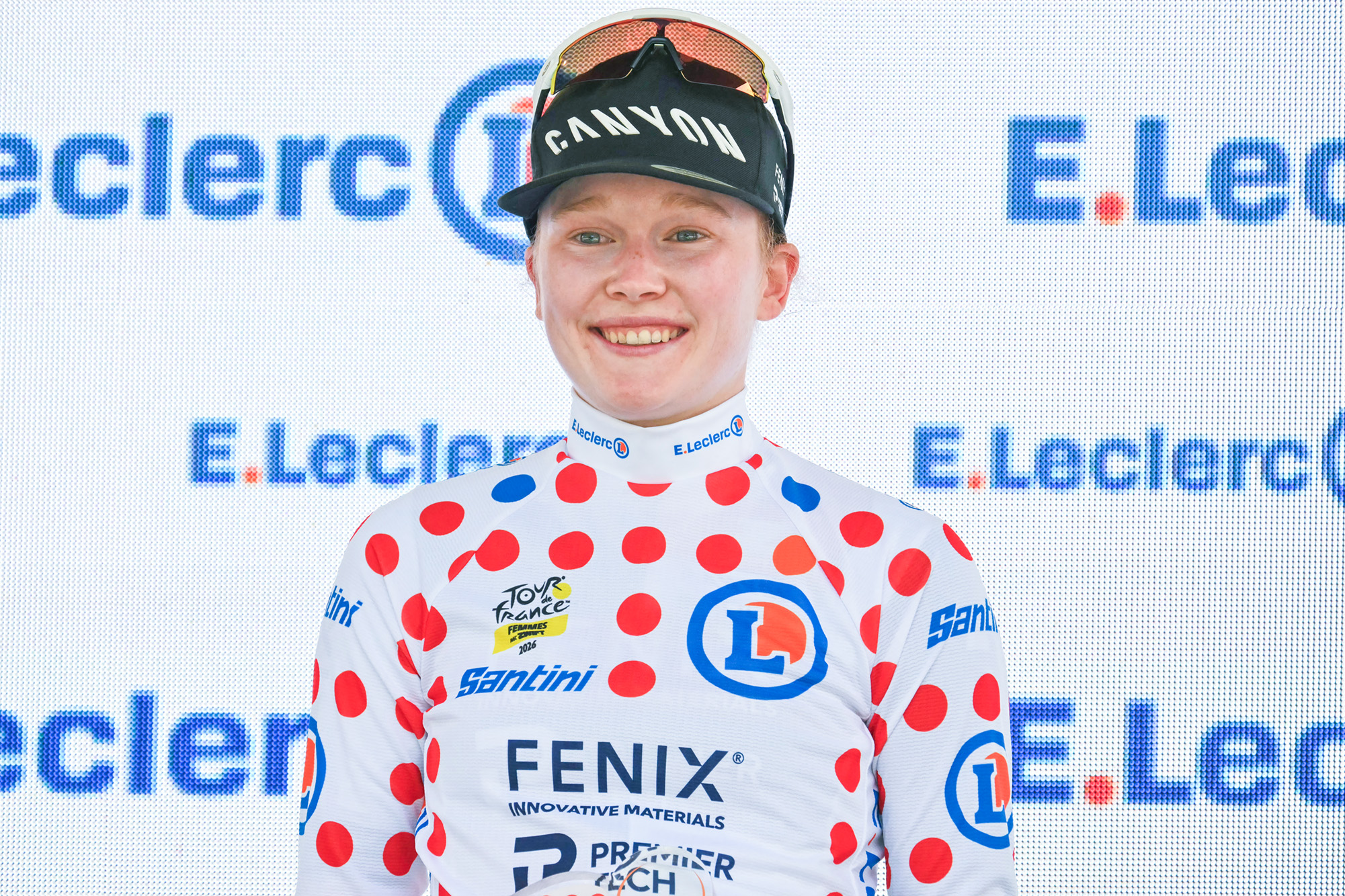 Fenix-Deceuninck's Dutch rider Puck Pieterse celebrates on the podium with the best climber's polka dot (dotted) jersey after the 3rd (out of 9) stage of the fifth edition of the Women's Tour de France cycling race, 156.5 km from Geneva to Poligny, in Poligny, central-eastern France on August 3, 2026. (Photo by NICOLAS TUCAT / AFP via Getty Images)