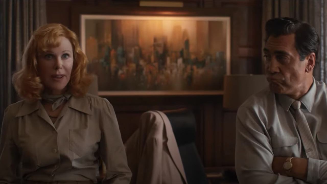 Nicole Kidman and Javier Bardem talking in an office in Being The Ricardos.
