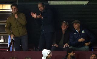 Prince William cheering with 3 friends at an Aston Villa game