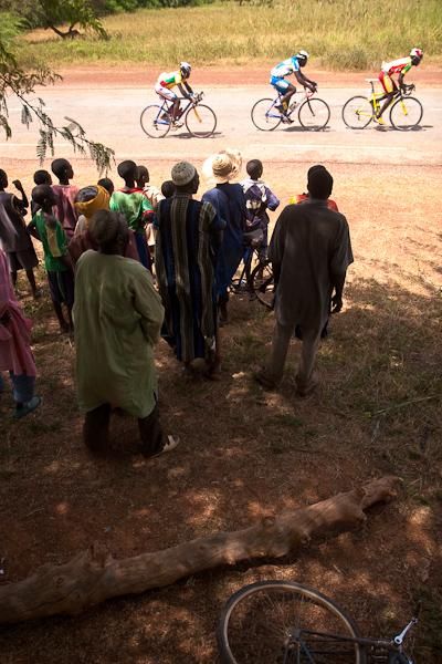 Spectators watch the race from the shade of an acacia tree.
