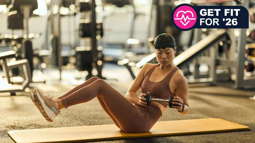 Woman doing dumbbell twist in gym