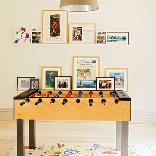 game room with football table and picture wall