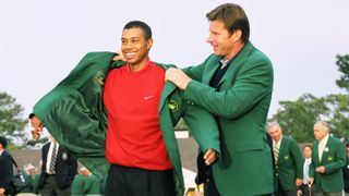 Nick Faldo helps Tiger Woods into the green jacket in 1997