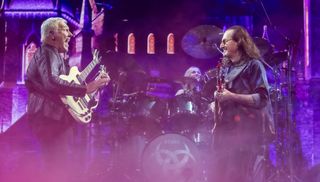 (L-R) Alex Lifeson, Anika Nilles, and Geddy Lee perform onstage earlier this month, at the Dickies Arena in Fort Worth, Texas