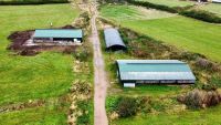 A site with three barns on rural farmland