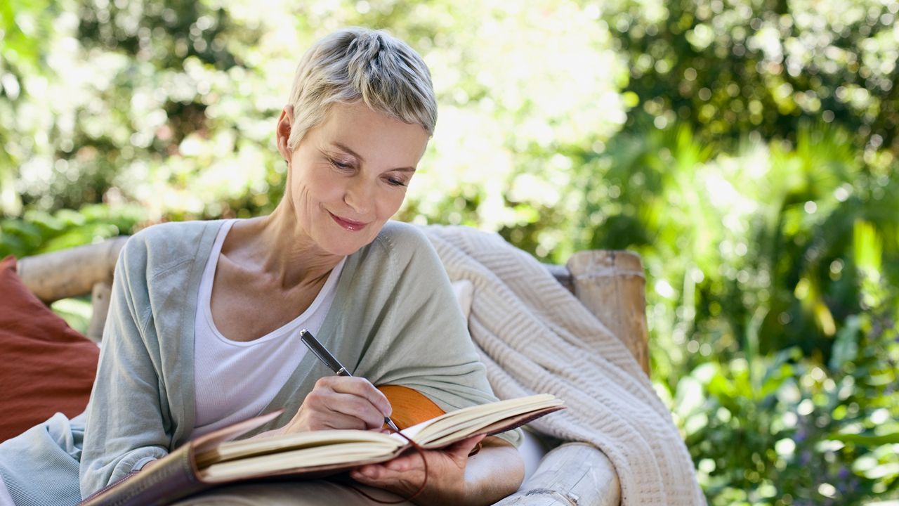 woman writing in a journal