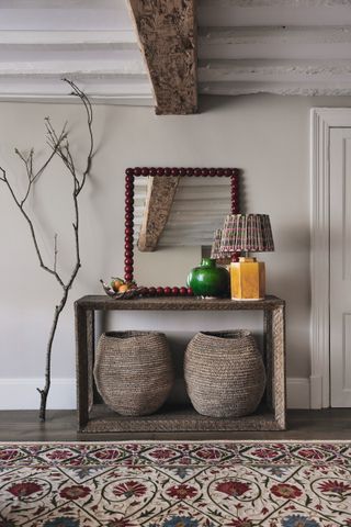 country console table with stools beneath