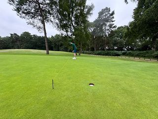 Barry Plummer using a string line to practice putting on the correct target line