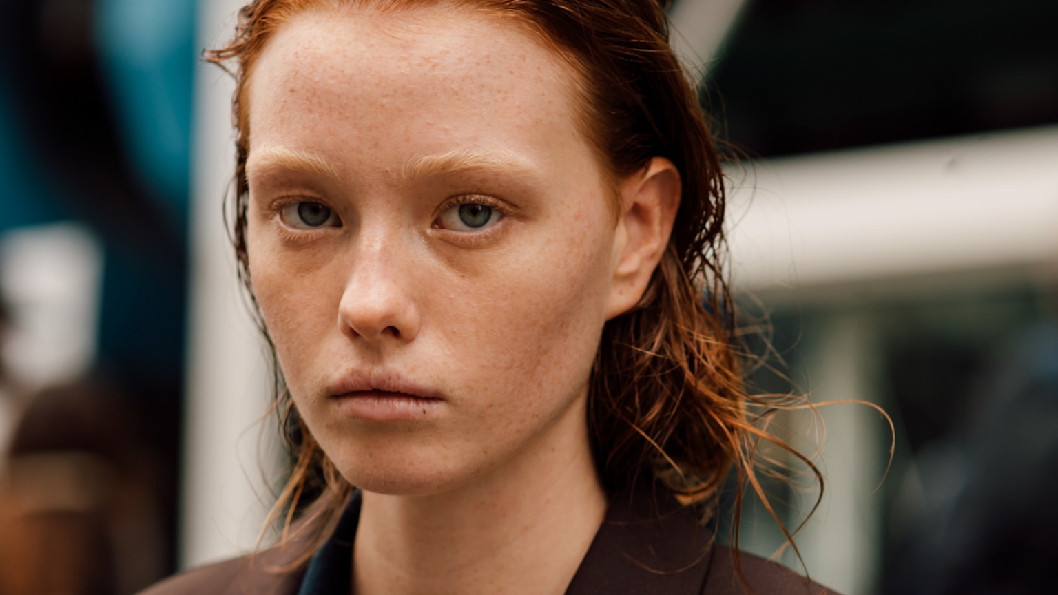 a redheaded woman with pale skin close up
