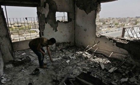 A man picks at rubble in a destroyed home in Misrata, Libya: Should Moammar Gadhafi finally give up power, Libya does not a set post-peace plan.