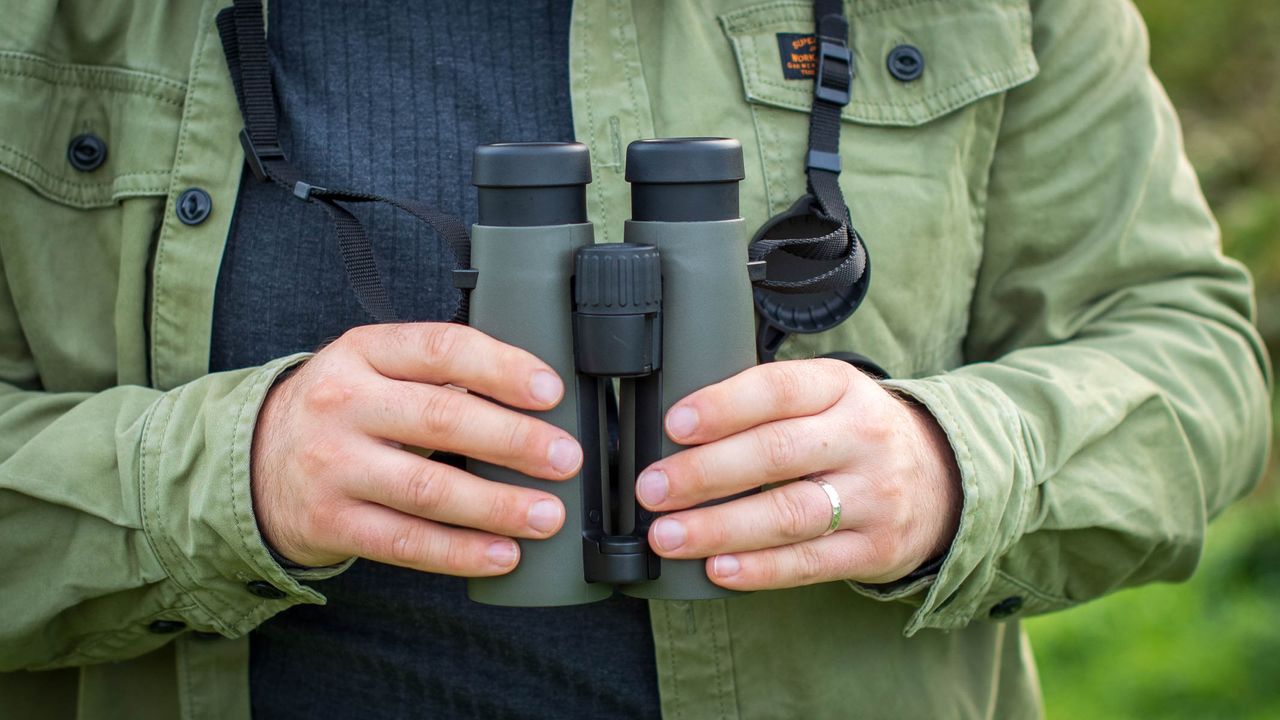 Leica Noctivid 10x42 front view in hands of author