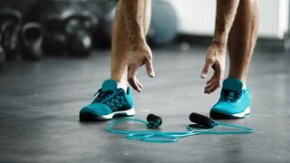 A man reaching for a weighted jump rope
