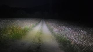 Olight Perun 2 lighting up a farm track with its 166m throw