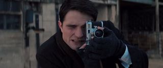 Robert Pattinson holding a camera