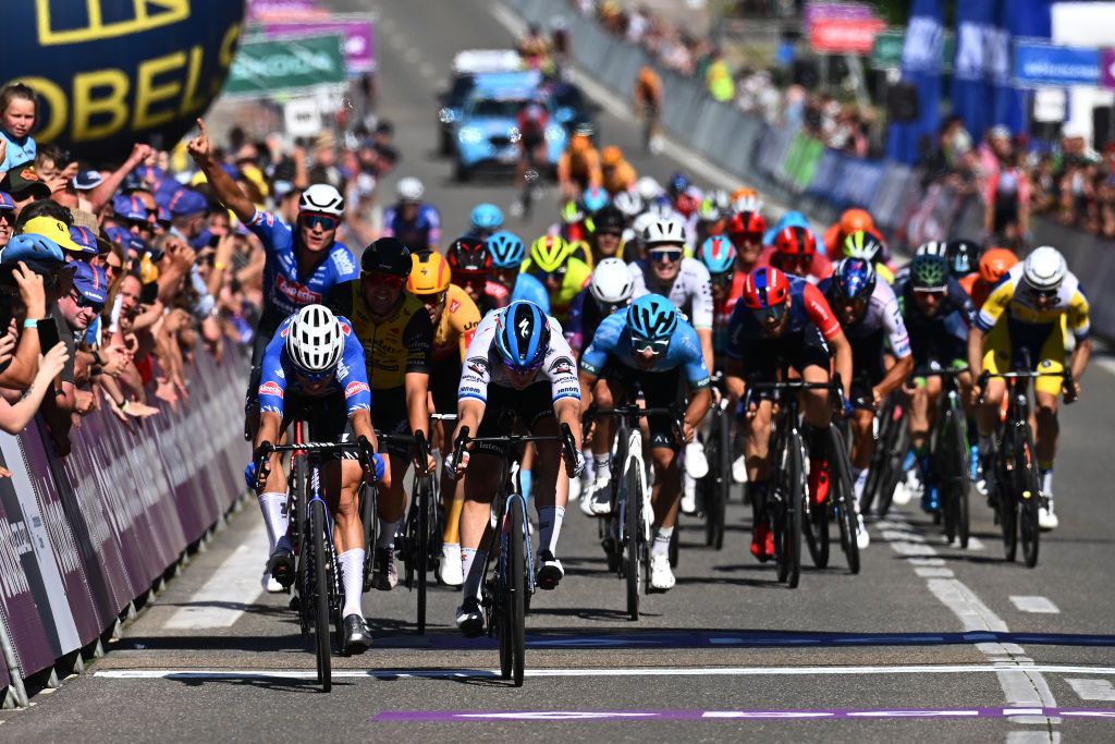 Jasper Philipsen (Alpecin-Deceuninck) takes the sprint victory on stage 1 of the Baloise Belgium Tour as teammate Mathieu van der Poel celebrates in the background