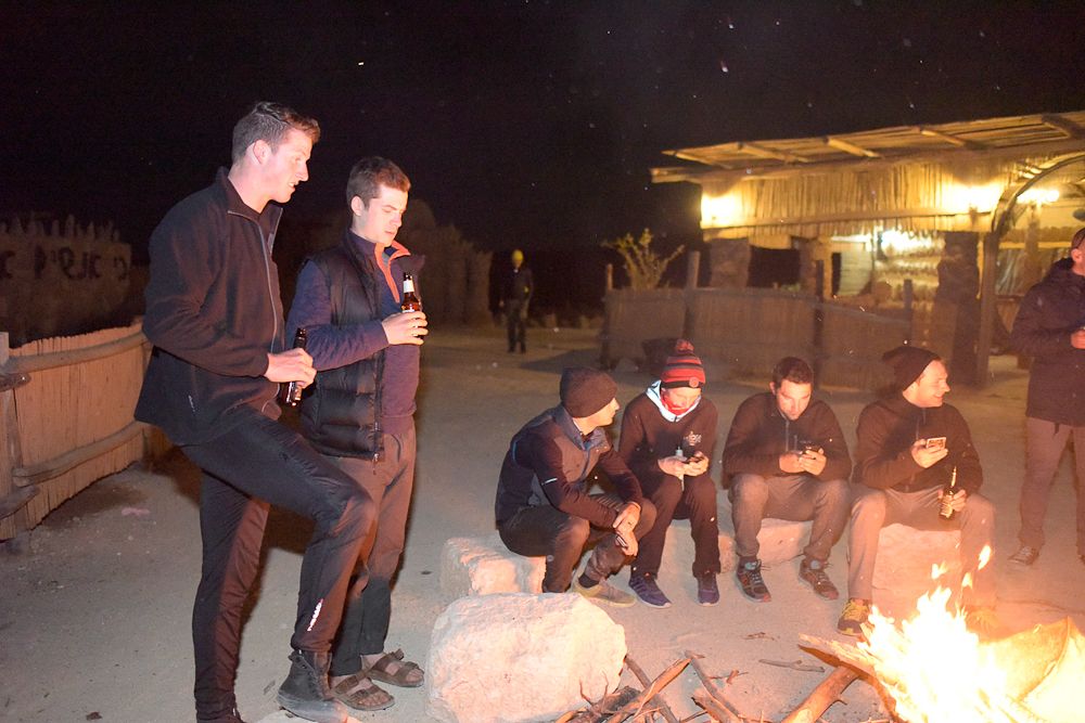 Jason Lowndes and Ben Perry drink a beer with teammates in the Bedouin village.