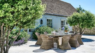 country patio with planting and large oval garden dining table