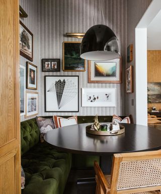 A maximalist seating nook in a maximalist kitchen with a gallery wall