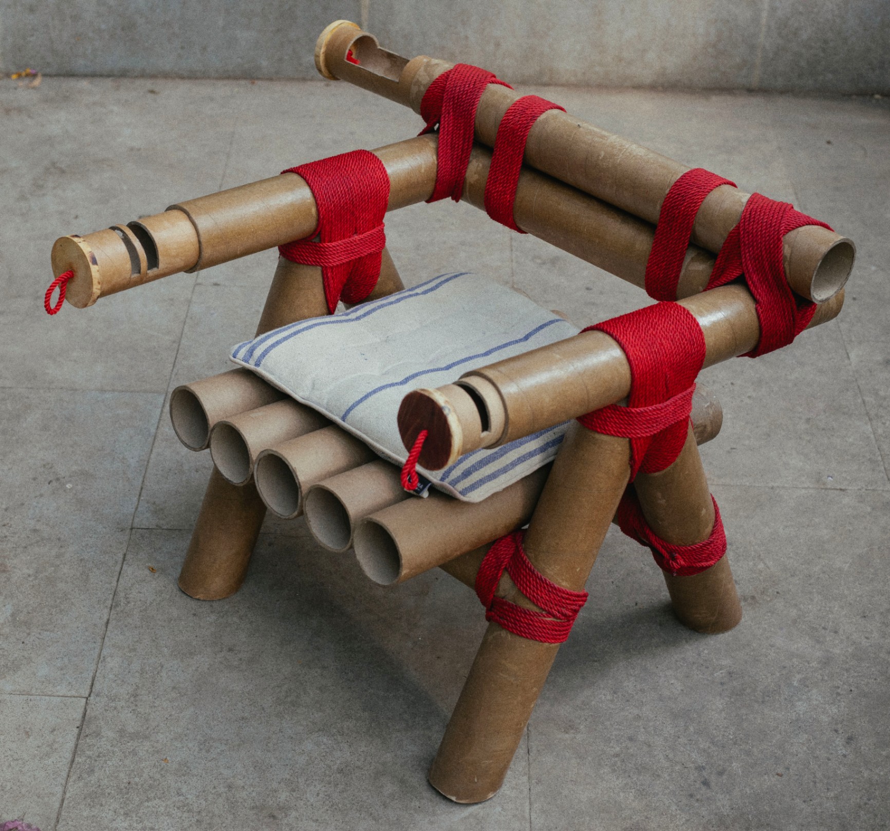 chair made from cardboard tubes tied together with rope