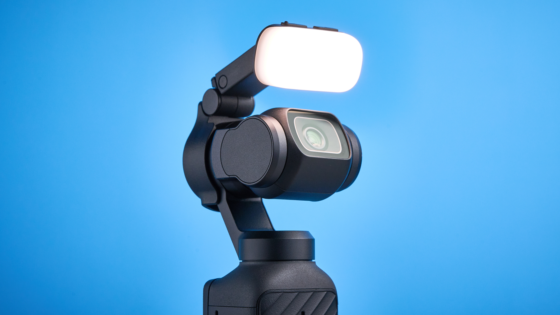 DJI Osmo Pocket 4 against a blue background