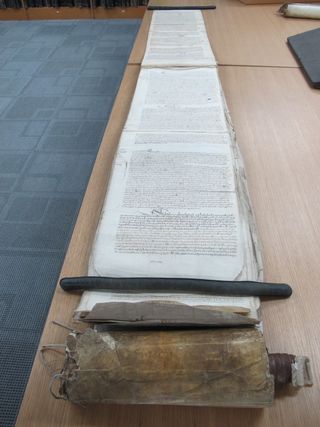 A 13-foot-long (4 meters) scroll stretched out on a table at The National Archives in the United Kingdom.