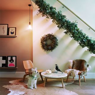 living room with dog and wreath on wall