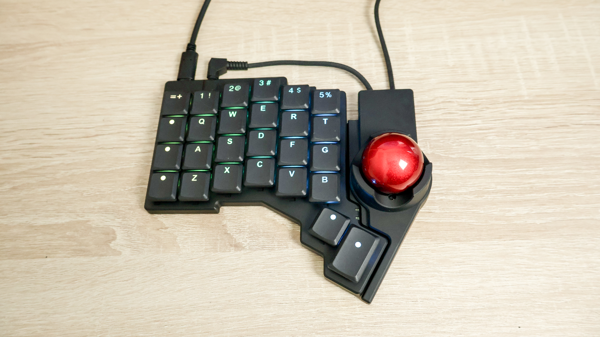 ZSA Voyager keyboard with Navigator (trackball) on a desk