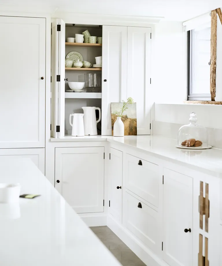 All-white kitchen with ivory worktops and cupboards