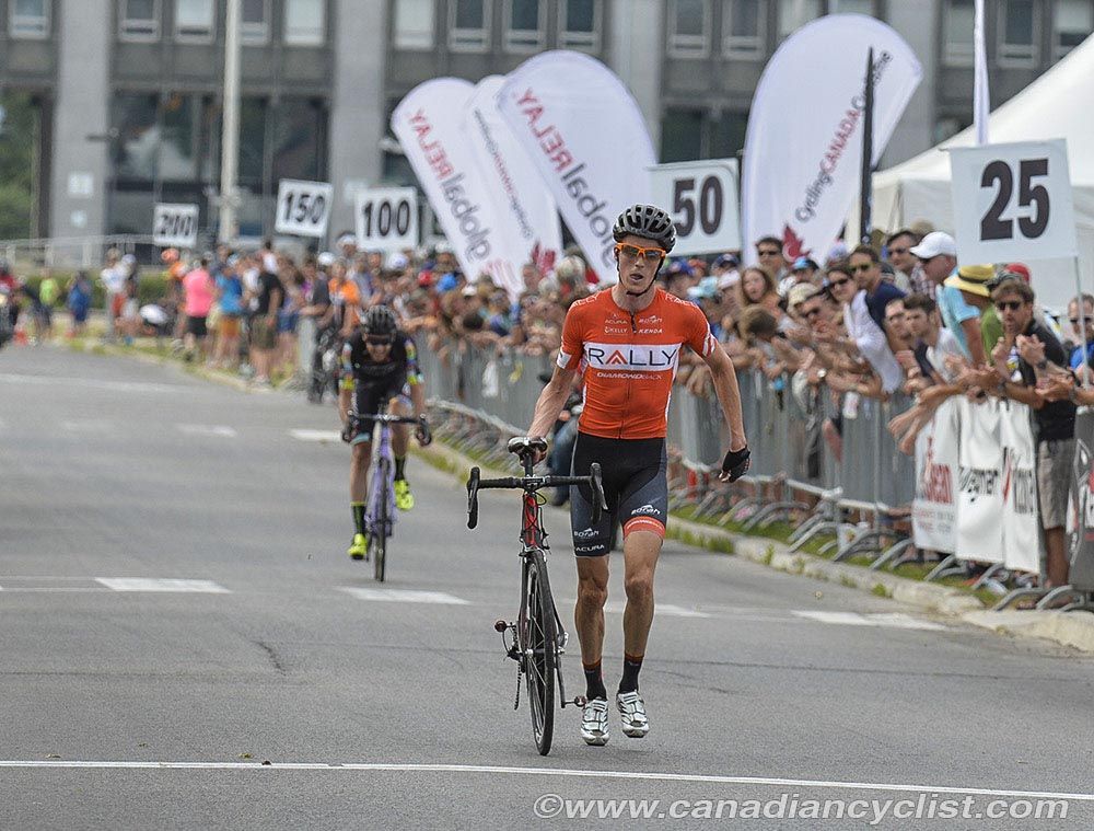 Will Routley (Rally Cycling) carries his bike across the line to finish 3rd
