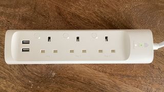 TP-Link Kasa Smart Wi-Fi Powerstrip KP303 on a wooden table