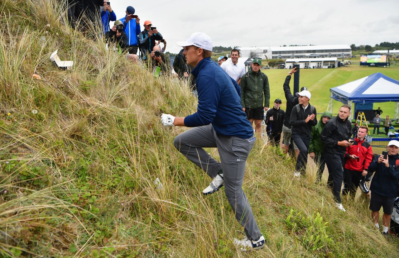 Jordan Spieth walks up a dune at the 2017 Open