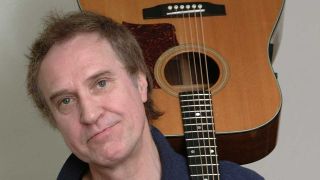 Ray Davies holding an acoustic guitar 