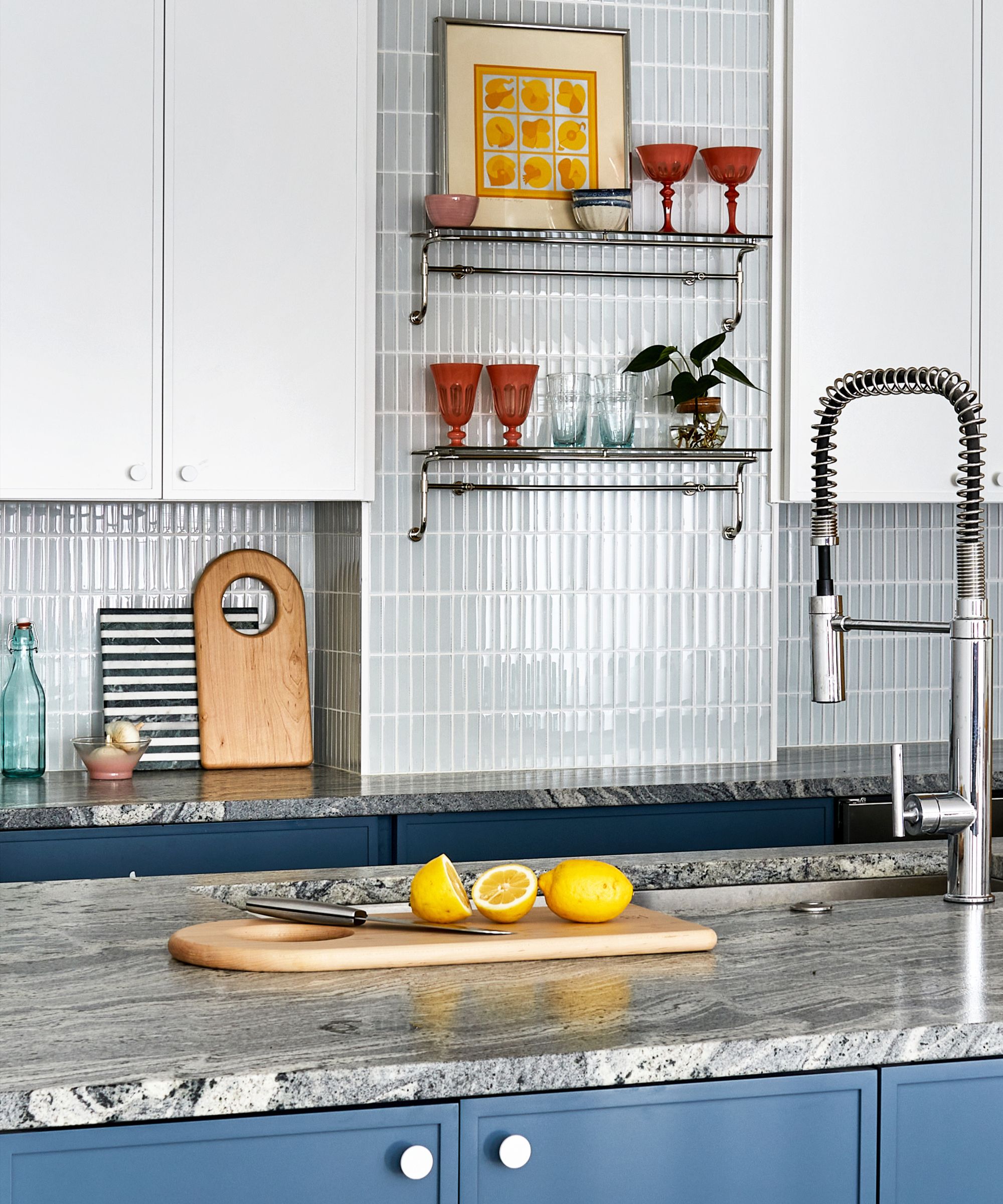 Modern kitchen with marble island and zeillage backsplash with shelves of glassware