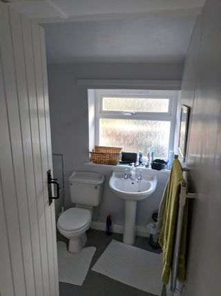 'Before' shot of plain white bathroom